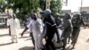Security forces transport with a blanket the remains of some of the 11 victims of a double blast in the northern Cameroonian city of Maroua, July 22, 2015. 