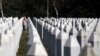 A Bosnian Muslim woman reacts as she walks among gravestones at the memorial centre of Potocari near Srebrenica, 150 kms north east of Sarajevo, Bosnia, Aug. 14, 2018.
