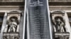FILE - A banner listing names of domestic violence victims hangs from Paris' city hall during a protest dedicated to the memory of women killed by their spouses or ex-spouses in 2019 and against violence against women, in Paris, Aug. 28, 2019.