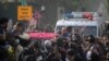 Supporters sprinkle rose petals on a car carrying former Prime Minister Nawaz Sharif, as he makes his way to the airport to travel for a medical treatment in London, outside his residence in Raiwind, near Lahore, Pakistan Nov. 19, 2019.
