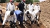 Health workers remove earth contaminated by lead from a family compound in the village of Dareta in Gusau, Nigeria, June 10, 2010. 