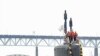 The attack submarine USS Virginia (SSN 774) makes her way up the Thames River to Submarine Base New London, Connecticut