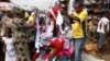 In this photo taken June 18, 2012, people buy secondhand clothes at Katangua market in Lagos, Nigeria. 