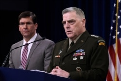 Defense Secretary Mark Esper, left, and Chairman of the Joint Chiefs of Staff Army Gen. Mark Milley, right, during a briefing at the Pentagon in Washington, March 2, 2020.