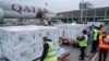 Airport officials receive boxes of Moderna coronavirus vaccine after their arrival at the airport in Nairobi, Kenya, Sept. 6, 2021. 