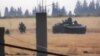 This image made from amateur video released by the Shaam News Network and accessed June 18, 2012, purports to show a Syrian military tank in Daraa, Syria. 
