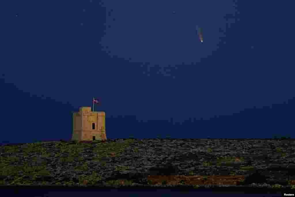 The Comet C/2020 or &quot;Neowise&quot; is seen in the sky behind St. Mark&#39;s Tower, a 17th century coastal fortification near the village of Bahar ic-Caghaq, Malta.