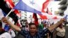 FILE - A demonstrator carries a Panamanian flag during a protest against U.S. policies in Latin America, in Panama City, April 9, 2015. On Wednesday, a U.S. special envoy urged Panama to stop Iranian ships from flying its flag, which allows Tehran to evade Washington's sanctions.