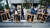 FILE - People opposing the Tokyo 2020 Olympics set to open in July amid the COVID pandemic, march near Tokyo's National Stadium, in Tokyo, Japan, May 9, 2021.