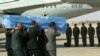 FILE - The crew of a Brazilian military plane stands at attention as the coffin with the body of the U.N. special envoy to Iraq, Sergio Vieira de Mello is put on the plane at the airport in Baghdad, Aug. 22, 2003.