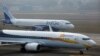 An IndiGo Airlines aircraft and JetKonnect Boeing 737 aircraft taxi at Mumbai's Chhatrapathi Shivaji International Airport on February 3, 2013.