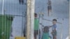 FILE - An undated image provided by Amnesty International purportedly shows children playing near a fence at an Australian-run detention center in the Pacific island nation of Nauru. 