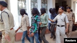 Police escort men accused of a gang rape to a court in Datia district in the central Indian state of Madhya Pradesh, March 18, 2013.