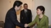 South Korean President Park Geun-hye, right, shakes hands with Japanese Prime Minister Shinzo Abe, left, as U.S. President Barack Obama looks on before their trilateral meeting at the U.S. Ambassador&#39;s Residence in the Hague, Netherlands, Tuesday, March 2