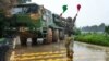 This handout photograph, taken on May 23, 2024, and released by the Eastern Theater Command of China's People's Liberation Army, shows a soldier leading a Chinese rocket launcher at a base during a military drill in eastern China's Fujian province.
