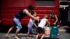 This photo taken on March 14, 2019 shows residents of Barangka, in Manila, gathering water.