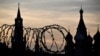 (FILES) This photograph shows a view of the Kremlin taken on May 17, 2023 through the barbed wire of a municipal technical facility in Moscow.