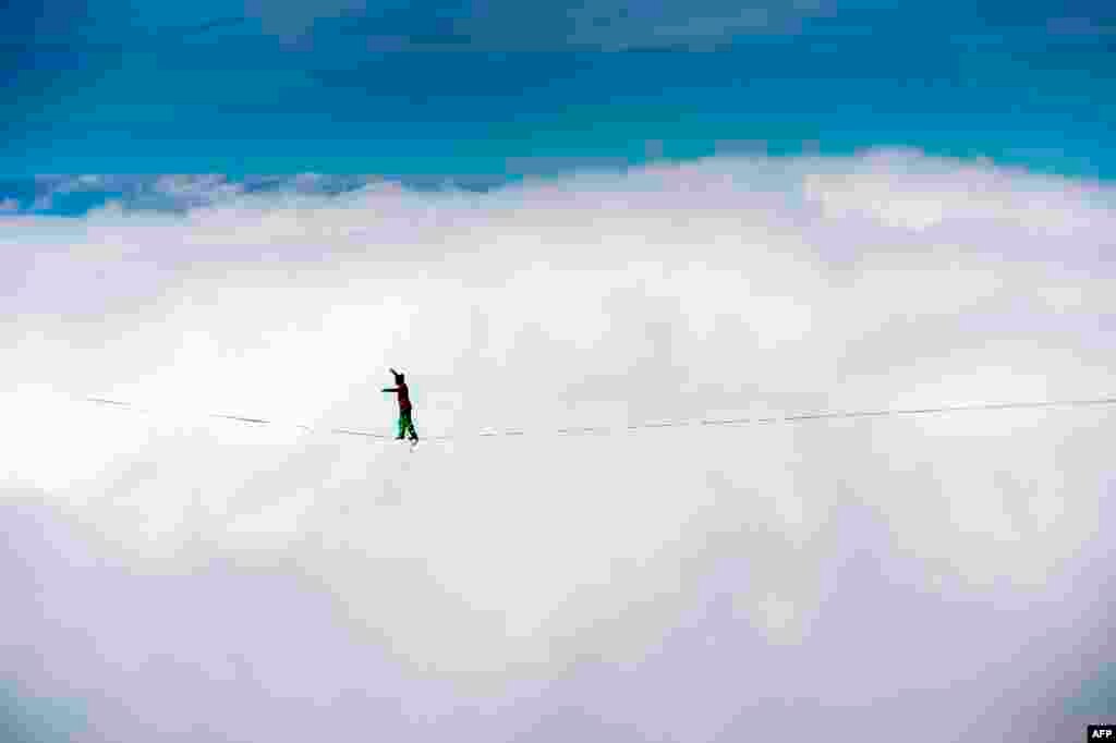 France's Guillaume Rolland walks on the line during the Highline Extreme event in Moleson peak, western Switzerland, Sept. 26, 2015. 