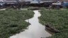 A 2011 global survey aimed at guiding city planners show African megacities at especially high risk from rising sea levels. Above, a Hyacinth-covered lagoon near the Makoko slum in Lagos, Nigeria, Oct. 2011 (file photo).