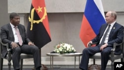 FILE - Angola's President Joao Lourenco, left, speaks to Russia's President Vladimir Putin at the BRICS summit in Johannesburg, South Africa, July 26, 2018. 