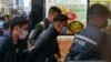 FILE - Stand News chief editor Patrick Lam (C) is brought to the news outlet's office building in handcuffs after police were deployed to search the premises in Hong Kong's Kwun Tong district on Dec. 29, 2021.