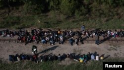 Un agente de la patrulla fronteriza separa a menores no acompañados de un grupo de inmigrantes centroamericanos que cruzaron el Río Grande en México hacia la localidad La Joye, en Texas, EE. UU.