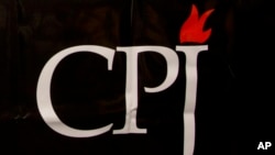 FILE - The CPJ logo is seen on a banner at a media conference in Brussels, Belgium, Sept. 29, 2015. 