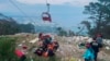 Rescue and emergency workers attend to passengers of a cable car outside Antalya, Turkey, on April 12, 2024. One person was killed and 10 injured when a cable car hit a pole and burst open, sending the passengers plummeting to the mountainside below, officials said.
