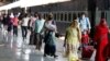 Migrant laborers, who arrived from Gujarat state on a train, rest before processding for their native villages in their home state of Uttar Pradesh in Prayagraj, India, May 6, 2020.