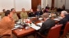 FILE - In this photo released by the Press Information Department, Pakistan Prime Minister Imran Khan, left, chairs a meeting of the country's National Security Committee, in Islamabad, Pakistan, Feb. 21, 2019.