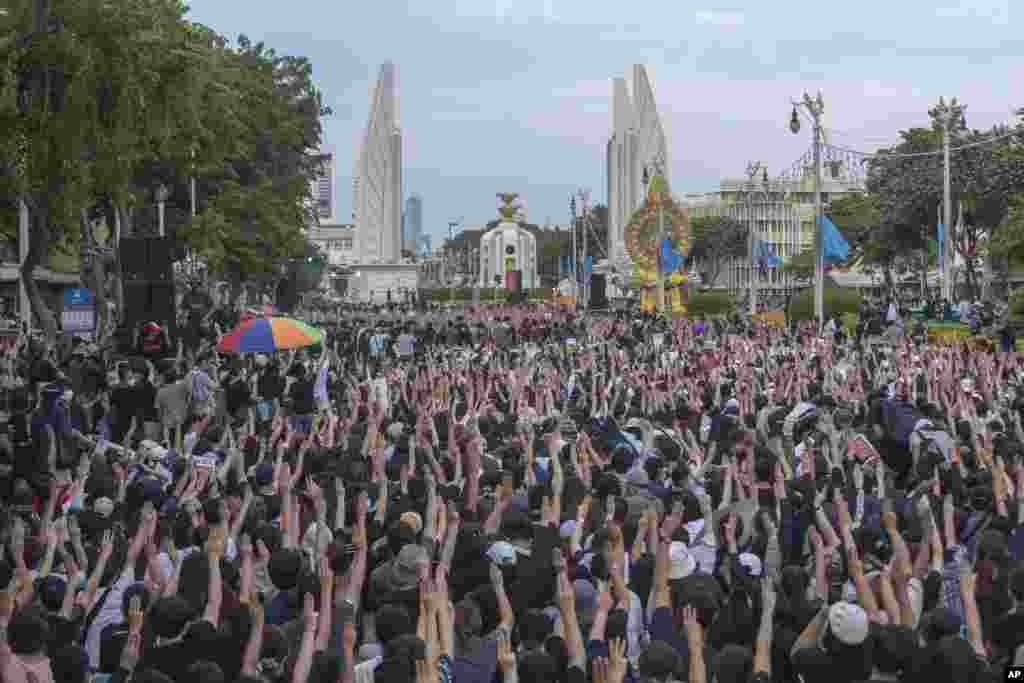 Pro-democracy students raise three-fingers, symbol of resistance salute, during a rally in Bangkok, Thailand. Protesters have stepped up pressure on the government to meet their demands - to hold new elections, to amend the constitution, and an end to intimidation of critics.