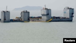 Barges are seen during a salvage operation of sunken ferry Sewol at the sea off Jindo, South Korea, March 22, 2017. 