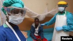FILE - A nurse and doctor stand by a patient in a Lassa fever ward at Kenema Government Hospital in southeastern Sierra Leone, Feb. 7, 2011.