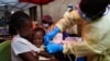 FILE- A child is vaccinated against Ebola in Beni, DRC, July 13, 2019.
