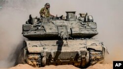 Soldados israelíes conducen un tanque en un lugar cerca de la frontera con la Franja de Gaza, en el sur de Israel, el 5 de mayo de 2024.