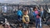 FILE - Syrian refugees check the damage following a fire that ripped through their refugee camp in the village of Yammouneh in Lebanon's eastern Bekaa Valley on Dec. 3, 2018.