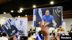 Miembros de la prensa sostienen fotos de compañeros acosados por el Gobierno de Daniel Ortega. [Foto de archivo]