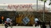 Commuters drive past a stationary aircraft belonging to Kingfisher airlines at the domestic airport in Mumbai, India, March 20, 2012. 