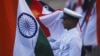 An Indian Navy soldier holds an Indian national flag during a dress rehearsal ahead of Navy Day celebrations in Mumbai, December 2, 2011. 