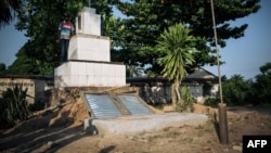 A man stands at the grave of the Banunu traditional chiefs in Yumbi, DRC, Jan. 28, 2019. Between Dec. 16 and Dec. 17, 2018, at least 535 people were killed in tribal mass killings in the Yumbi region, according to UN Joint Office for Human Rights.