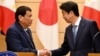 Philippines President Rodrigo Duterte shakes hands with Japanese Prime Minister Shinzo Abe at the end of their signing ceremony and joint remarks at Abe's official residence in Tokyo, Oct. 30, 2017.
