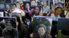 FILE - Students hold portraits of deceased former South Korean "comfort women" during a weekly anti-Japan rally in front of the Japanese Embassy in Seoul, South Korea.