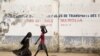 FILE - Girls walk on a road in Maroua, Cameroon, March 17, 2016. 