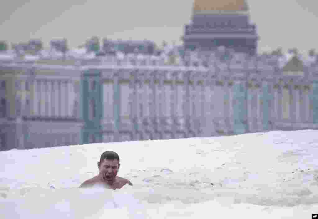 A man swims in an ice hole in the Neva River in St. Petersburg, Russia.