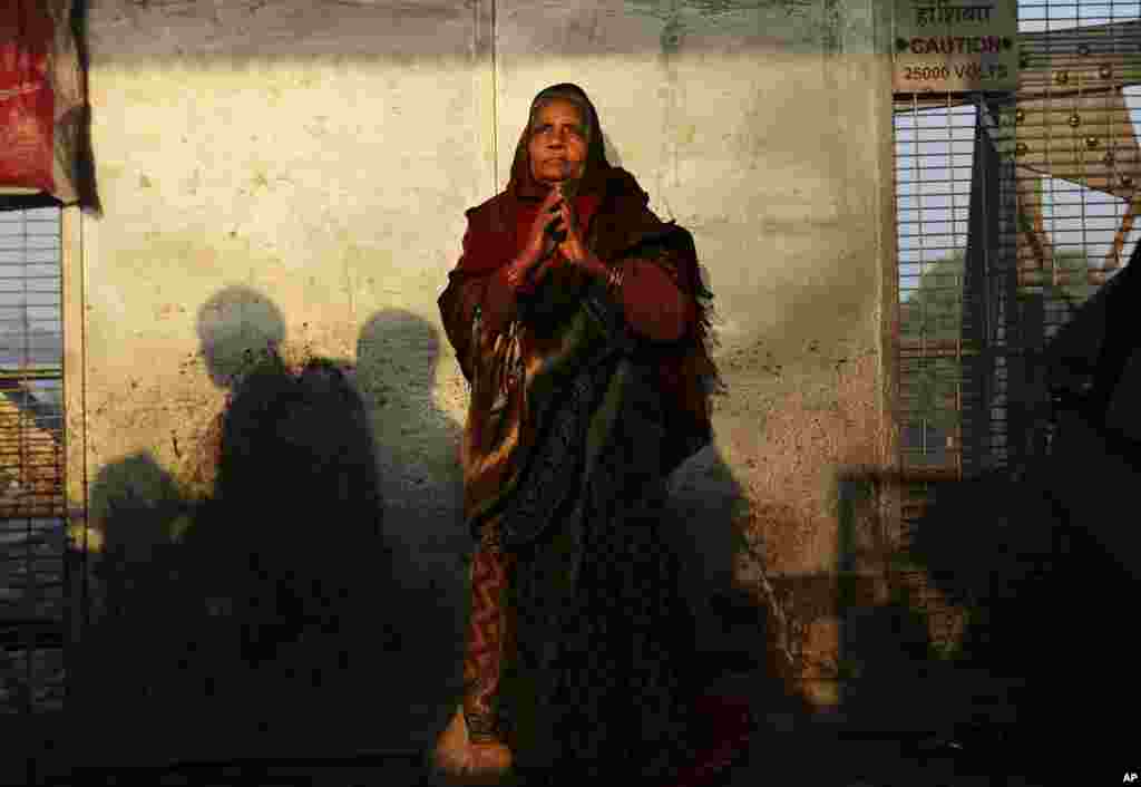 A woman stands on a platform near where a stampede took place a night before, at the station in Allahabad, India, Feb. 11, 2013.