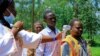 FILE - A Congolese health worker checks the temperature of a man before the launch of vaccination campaign against the deadly Ebola virus near Mangina village, near the town of Beni in North Kivu province of the Democratic Republic of Congo, Aug. 8, 2018.