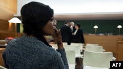 A Nigerian defendant waits in the courtroom prior to the start of a trial of a prostitution network case in Lyon, France, Nov. 6, 2019. 