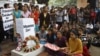 Indians gather next to a makeshift memorial to mourn the death of a 23-year-old gang rape victim, in Bangalore, India , Saturday, Dec. 29, 2012. 