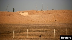 FILE - Moroccan soldiers are seen on an earth wall that separates areas controlled by Morocco and the Polisario Front in Western Sahara, Sept. 10, 2016.