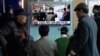 People watch a TV news program showing North Korean leader Kim Jong Un with superimposed letters that read: "North Korea has made nuclear warheads small enough to fit on ballistic missiles" at Seoul Railway Station in Seoul, South Korea, Wednesday, March 
